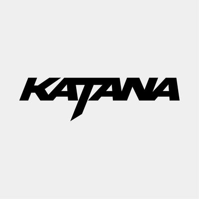 KATANA logo in bold, angular black text with a stylized “T” resembling a sword blade, evoking speed, precision, and aggressive design.