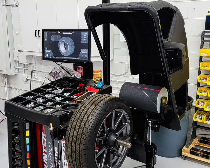 Hunter Road Force tire balancer machine displaying tire diagnostics with wheel mounted for service.