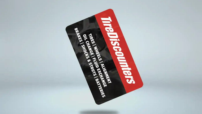 Tire Discounters credit card floating on light background, listing services like tires, oil changes, and alignments.