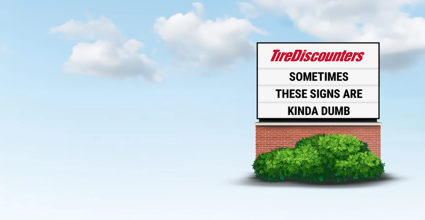Funny Tire Discounters sign reading sometimes these signs are kinda dumb.