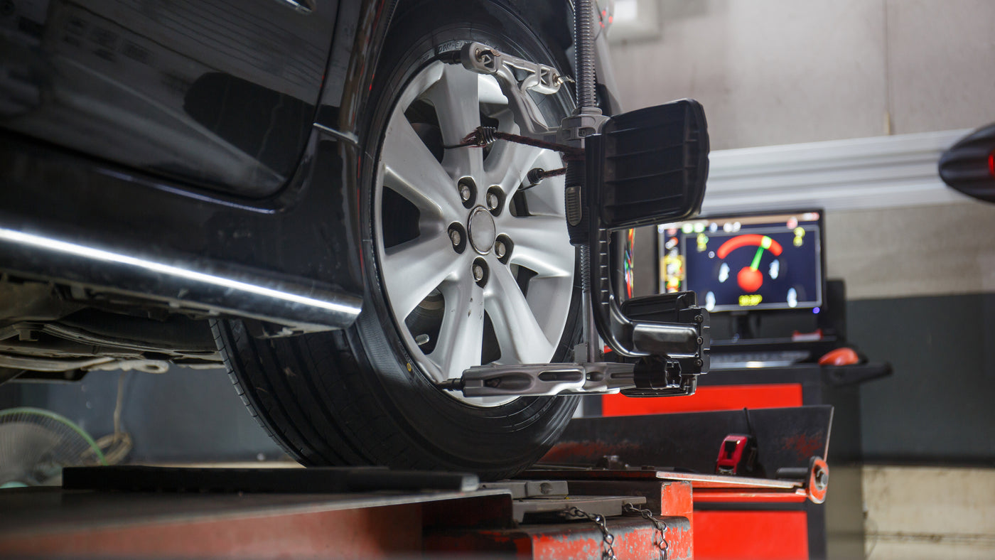 Wheel alignment in progress using computerized diagnostic tools at Tire Discounters — precision alignment service for safer driving.