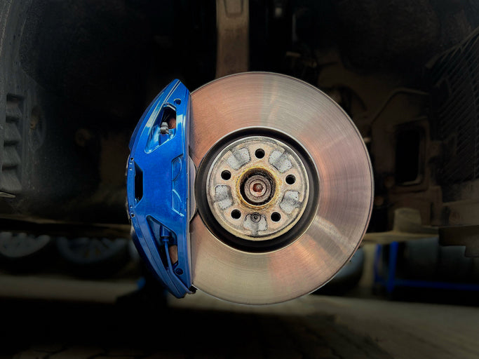 Brake rotor and blue caliper exposed during service | Expert brake repair and replacement at Tire Discounters