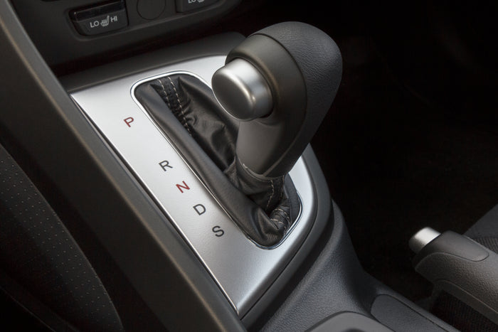 Close-up of an automatic transmission gear shift in a modern vehicle interior.