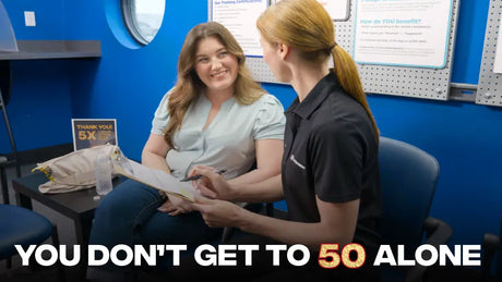 Customer smiling, speaking with a Tire Discounters employee