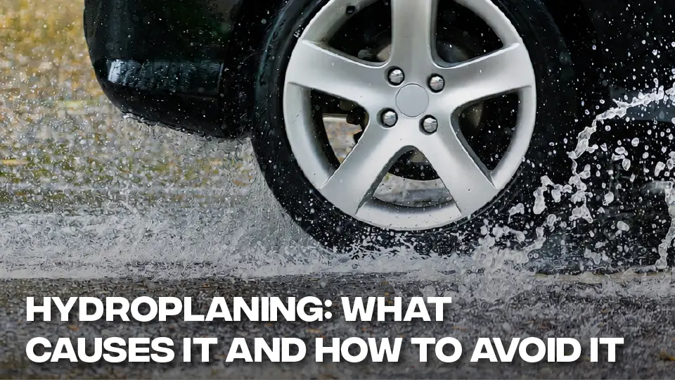 Car wheel splashing through standing water