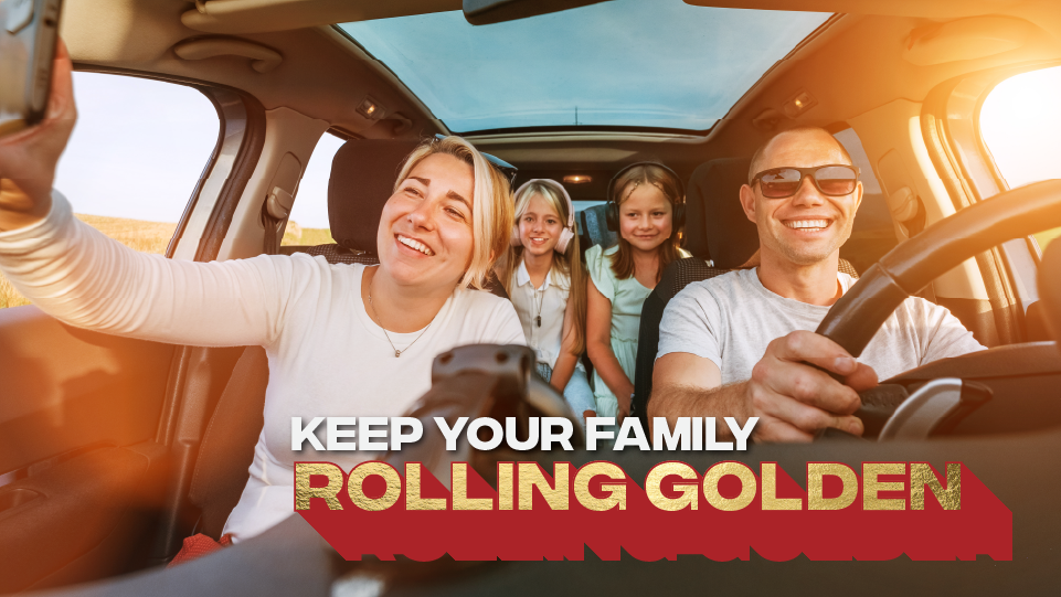 A family taking a selfie in a car with sunrise in the background