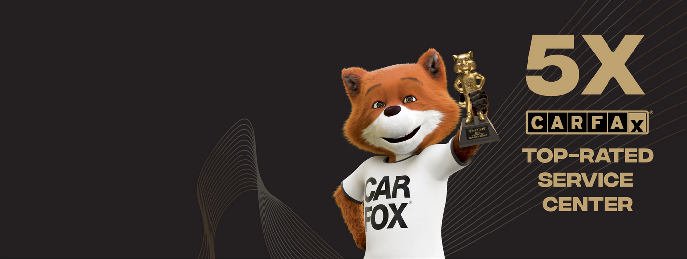 Animated fox character holding a trophy with '5X CARFAAX TOP-RATED SERVICE CENTER' text on a black background