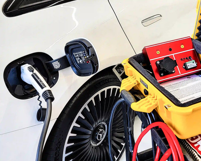 Mercedes-Benz EQS electric vehicle charging during diagnostic service with testing equipment connected.