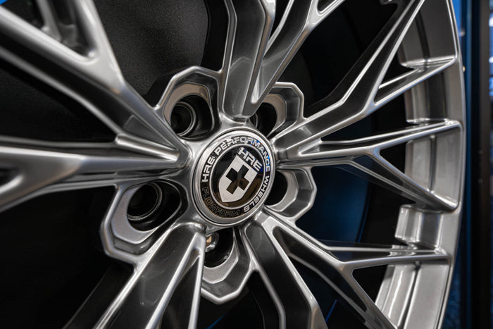 Close-up of HRE FlowForm performance wheel with multi-spoke design and detailed silver finish.