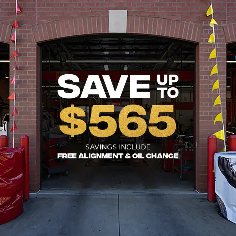 Tire Discounters service bay promoting savings up to $565, including a free alignment and oil change