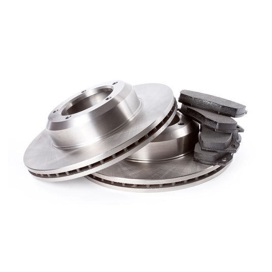 Close-up of new brake rotors and stacked brake pads, essential parts for automotive brake system replacement.
