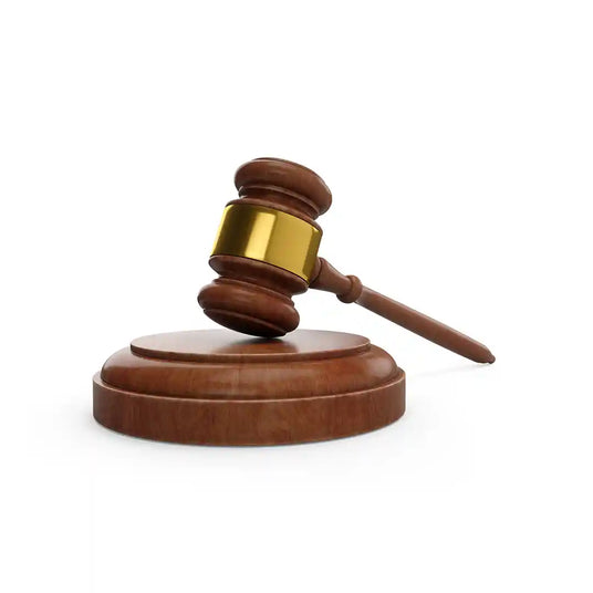 Judge’s gavel resting on a wooden sound block – a classic symbol of law, justice, and courtroom authority.