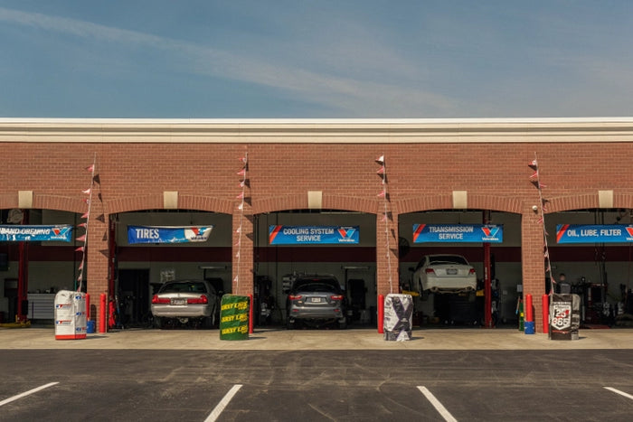 Tire Discounters store with open service bays labeled for tires, cooling system, transmission, and oil change services.