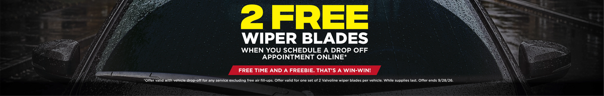 Promotional banner for windshield wiper blades with large yellow and white text reading '2 FREE WIPER BLADES' over a dark car window with raindrops, plus a red callout and small sample reviews at the bottom.